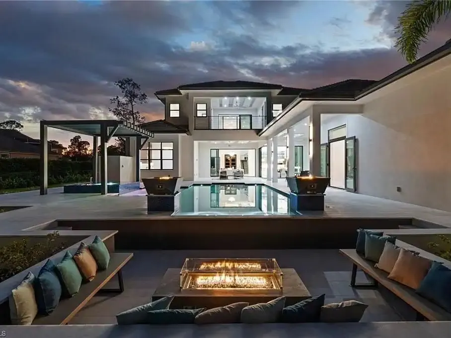 Twilight view of the pool terrace and fire pit at 2272 Oakes Blvd